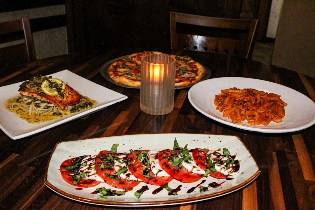 Services a-table-setting-with-pizza-salmon-pasta-and-tomato-salad-3iwjsfoli5e
